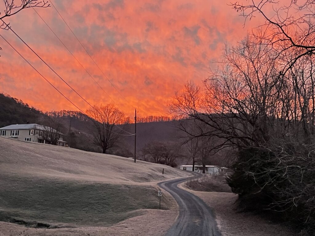 The sun setting the sky ablaze in the mountains - keeping us grounded as we discuss cash flow investments.